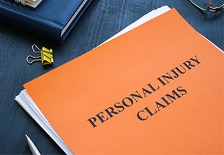 A stack of papers with personal injury claims on the table
