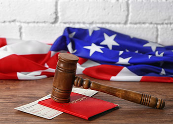 Gavel, passport, plane ticket and flag of USA