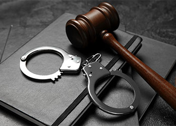 Gavel and Handcuff in table