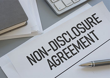 Non-disclosure Agreement file and pen in table