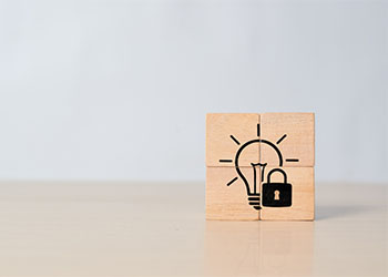 Light bulb and lock logo formed by wooden cubes