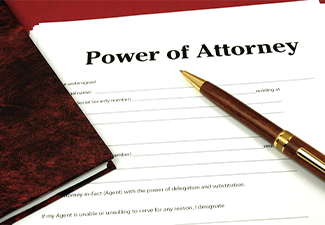 Power of Attorney Form ready to sign with book and pen