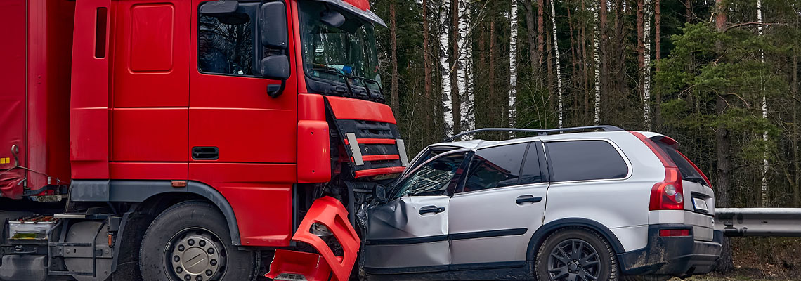 Collision between car and truck in highway