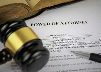 Power of Attorney file and gavel in table