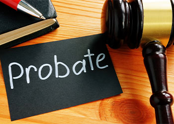 Word probate in paper with gavel in table