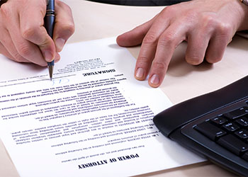 Man signing Power of Attorney Document