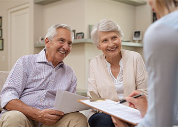 Senior couple discussing estate planning options with professional