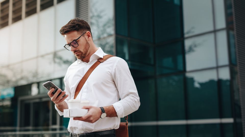 A professional looking at his cell phone
