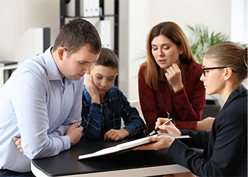 Divorced parents with their son visiting lawyer