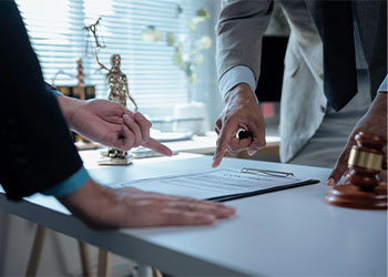 Legal professionals examining contract paper