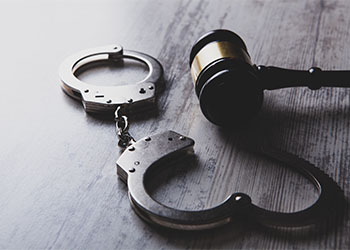 Gavel and handcuff in table