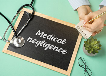 Board with word Medical Negligence and stethoscope
