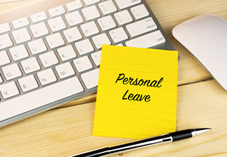 Personal leave on sticky note on work desk