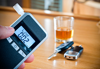 Alcoholic drink, breathalyzer and car keys
