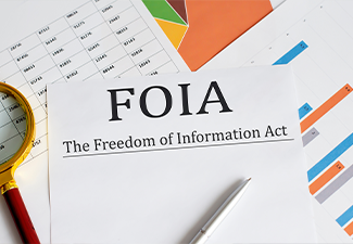 Paper with The Freedom of Information Act FOIA on a table