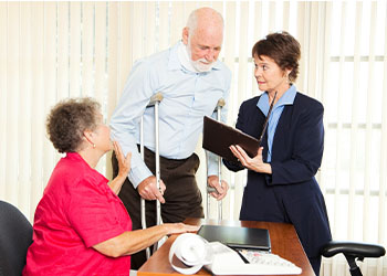 Injured man and his wife in attorney office
