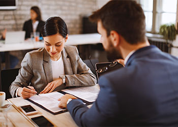 Young woman signs an employment contract