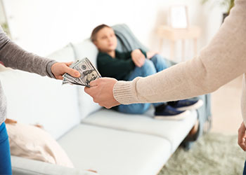 Man handing alimony money to wife