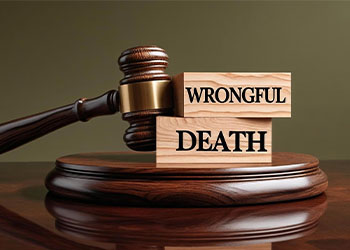Wooden block with word Wrongful Death and gavel in table