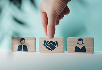 Wooden blocks with an icon of a woman and a man and mediation