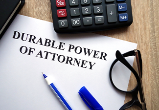 Durable power of attorney document, pen, glasses and calculator on desk
