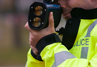 Police checking speed of vehicles in road