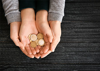 Women and her child holding coins in hand