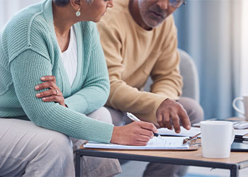 Senior couples signing estate planning document