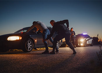 Police pull over and arrest a man for driving crime