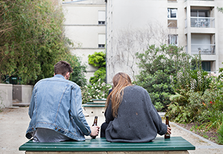 alcoholism, young people drinking beer on the bench