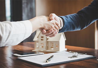 Estate agent and customer shaking hands after finished contract