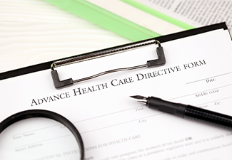 Advance health care directive blank form on A4 tablet lies on office table with pen