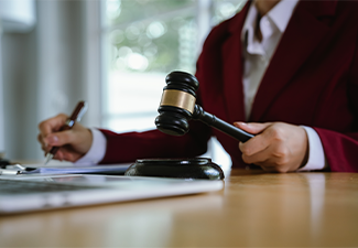 A lawyer carefully reviews and points to a contract document with a pen