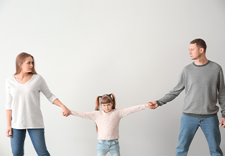 Divorced parents arguing about child custody on light background