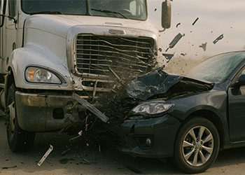Dramatic collision between large semi-truck and car on highway