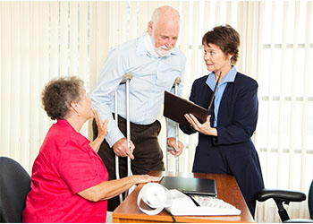 Injured man and his wife consulting with attorney