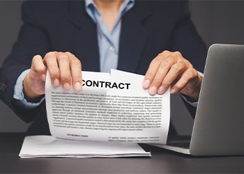 Businesswomen tearing contract paper