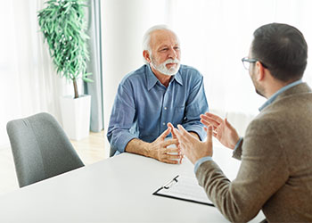 Senior man working with attorney to prepare estate plan
