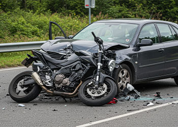 Collision between motorcycle and car in highway