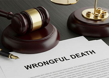 A gavel rests next to a document labeled wrongful death