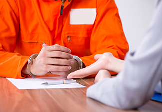 Young man meeting with advocate in pre-trial detention