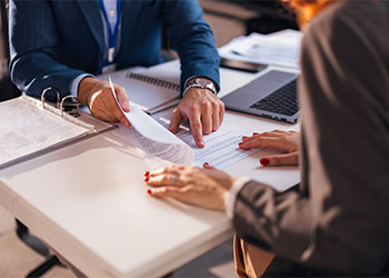 Businessman discussing contract terms with attorney