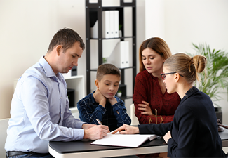 Divorced parents with their son visiting lawyer. Concept of child support