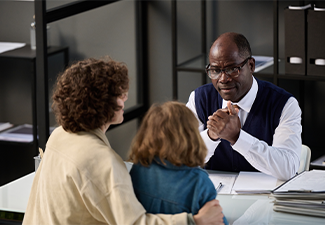 High angle portrait of young mother with child talking to caring lawyer
