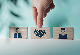 Wooden blocks with an icon of a woman and a man and mediation