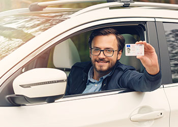 Young man showing his driving license
