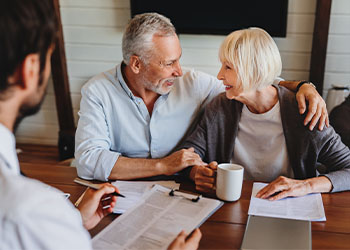 Senior couples discussing estate plan options with professional