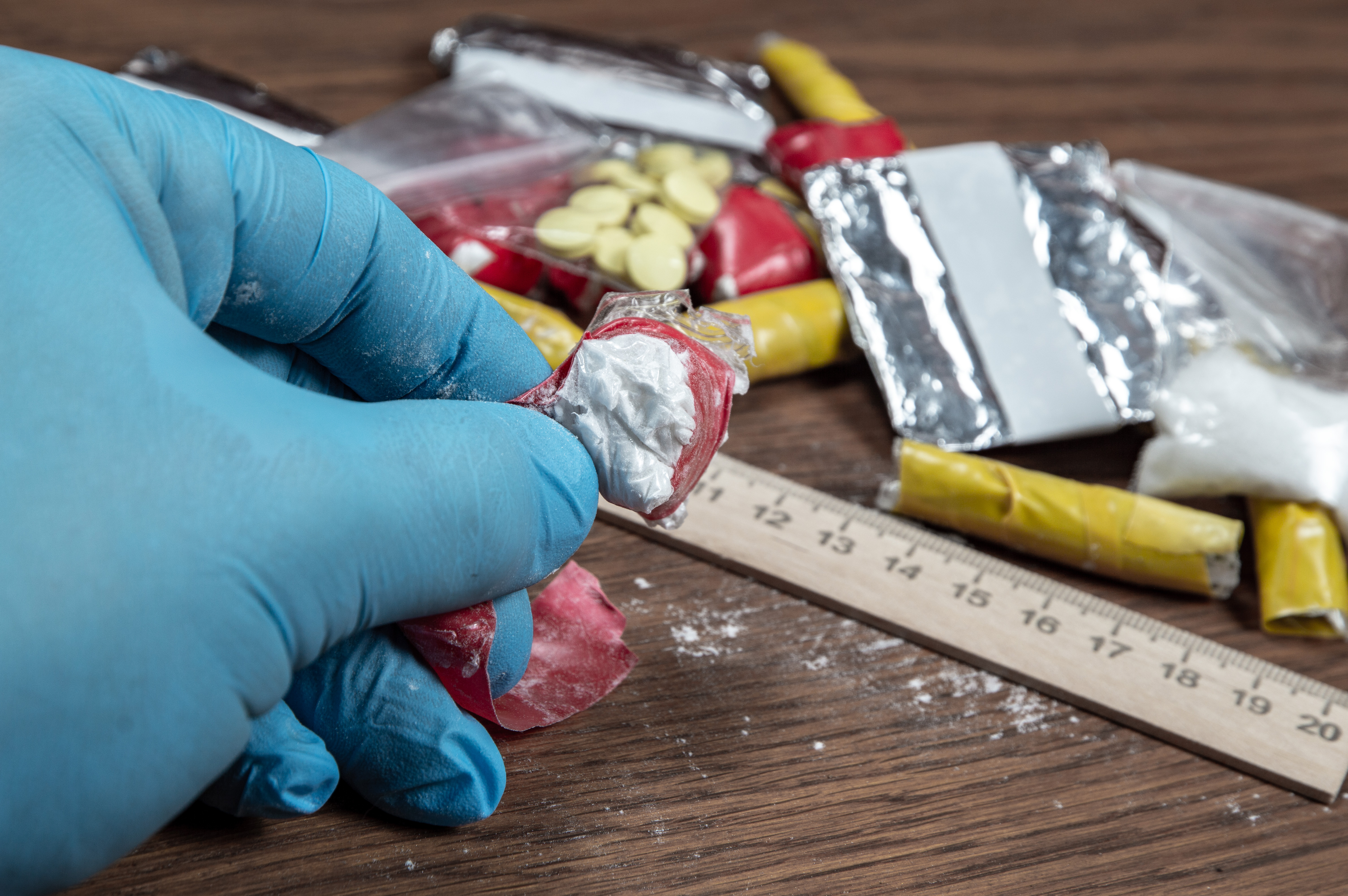 Forensic expert reviewing drug smuggling crime evidence