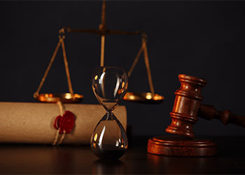 Wooden gavel, hourglass and stamp on testament and last will