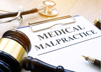 Clipboard with documents about medical malpractice and gavel